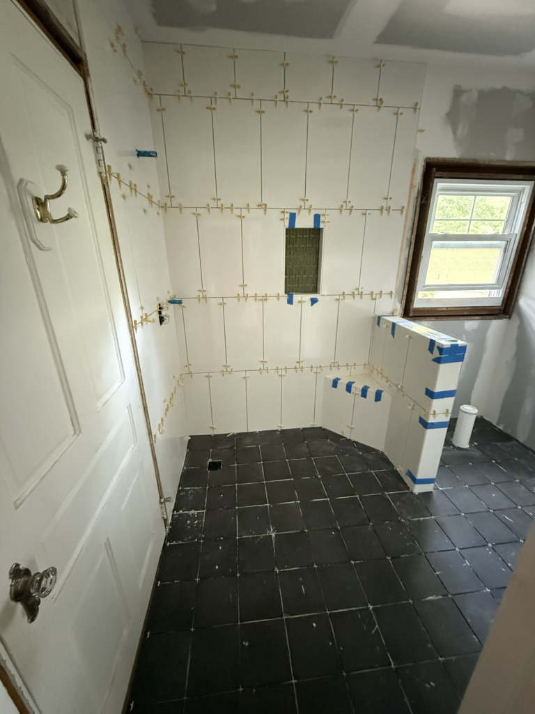 White shower tile installation during bathroom remodel in Clayton NC