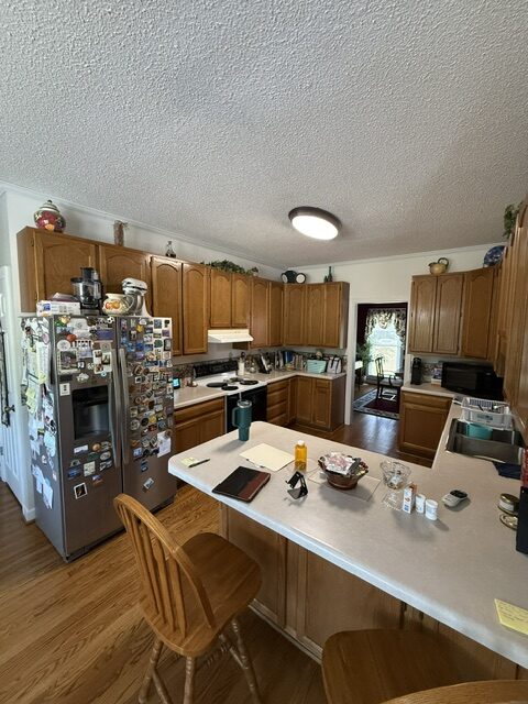 Kitchen remodeling Clayton NC before photo with oak cabinets and laminate countertops