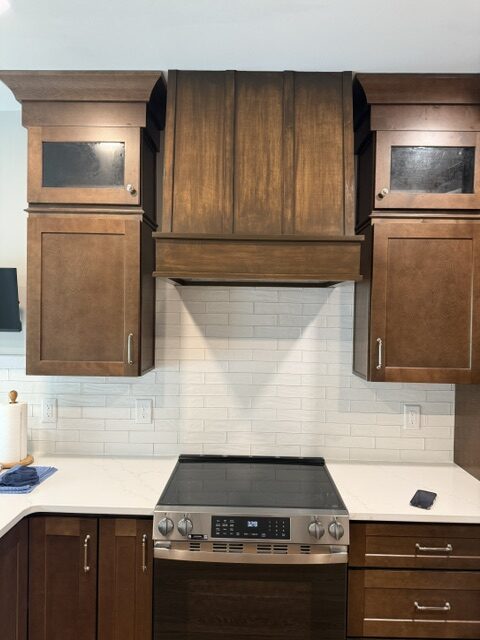Completed kitchen remodeling Clayton NC project with dark wood cabinets and white countertops